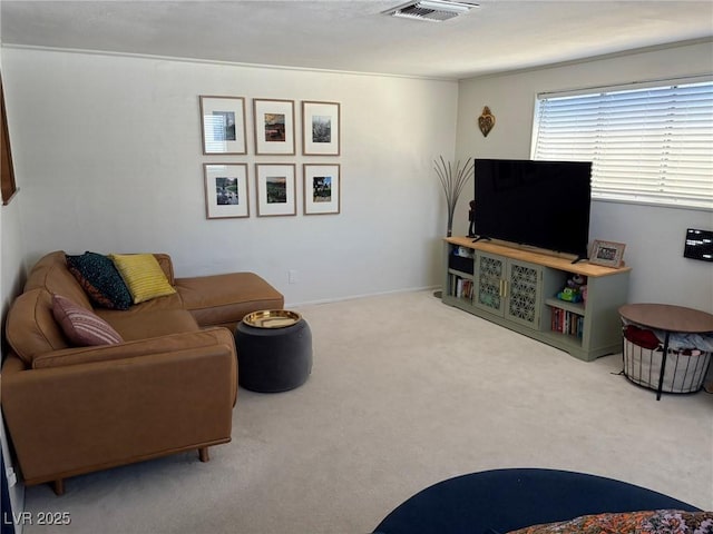 carpeted living room with visible vents and baseboards