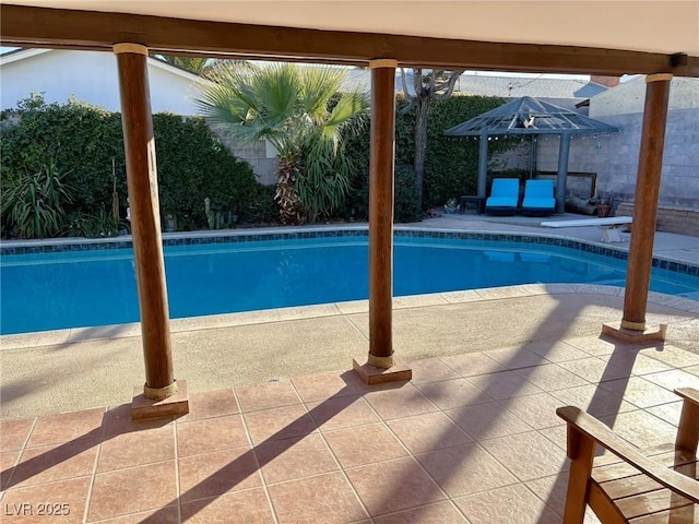 view of swimming pool featuring a fenced backyard, a fenced in pool, and a patio