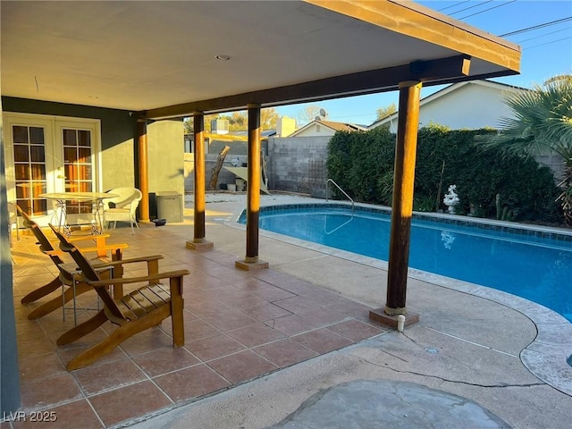 view of swimming pool with a fenced backyard, a fenced in pool, and a patio