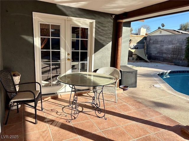 view of patio with a fenced in pool and french doors