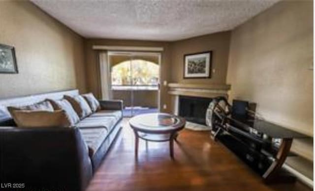 living room featuring hardwood / wood-style floors and a textured ceiling