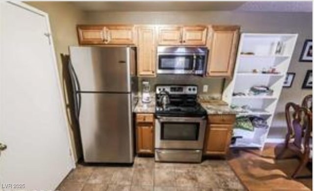 kitchen featuring appliances with stainless steel finishes and light brown cabinets