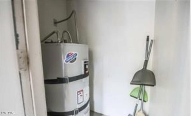 utility room featuring strapped water heater