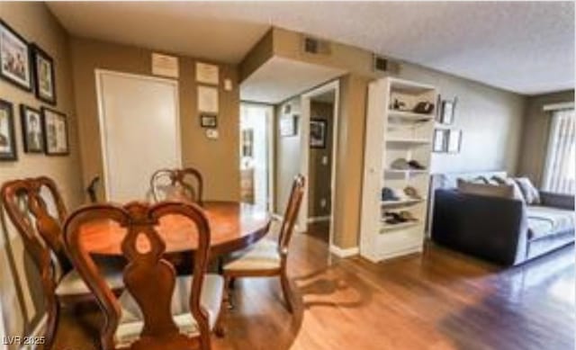 dining space with dark hardwood / wood-style floors