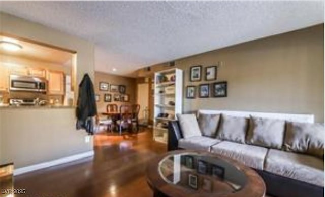 living room featuring hardwood / wood-style flooring and a textured ceiling