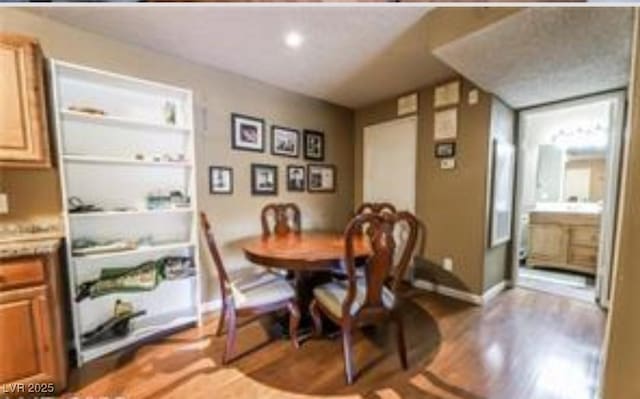 dining space with hardwood / wood-style flooring