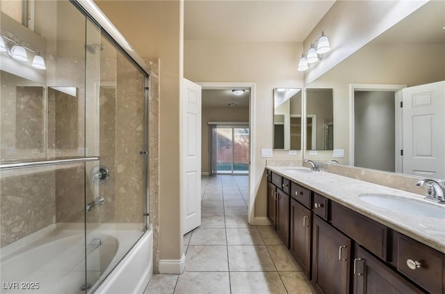 bathroom featuring tile patterned flooring, vanity, and shower / bath combination with glass door