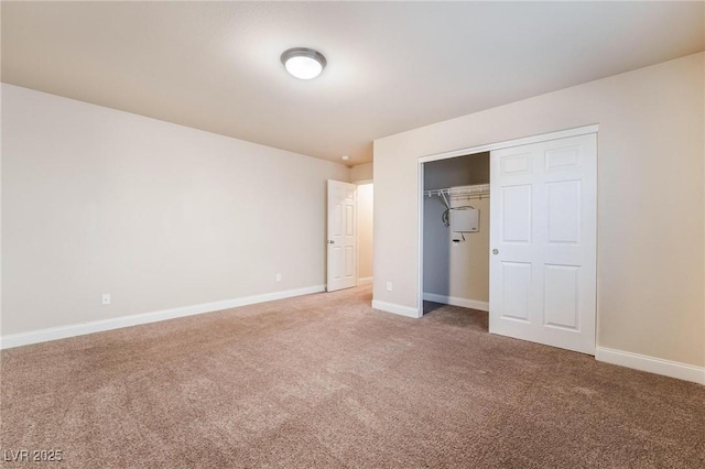 unfurnished bedroom with carpet floors and a closet