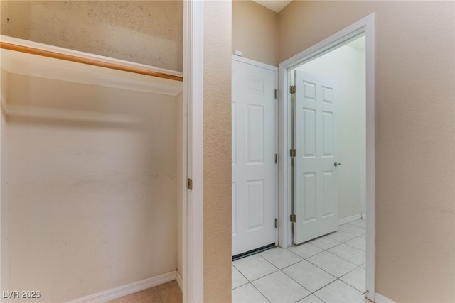 hallway featuring light tile patterned flooring