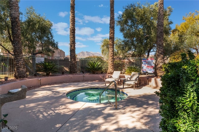 view of pool with a community hot tub, a mountain view, and a patio