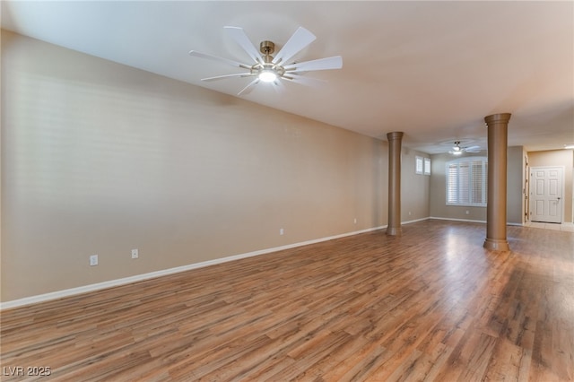 unfurnished room with decorative columns, ceiling fan, and light hardwood / wood-style floors