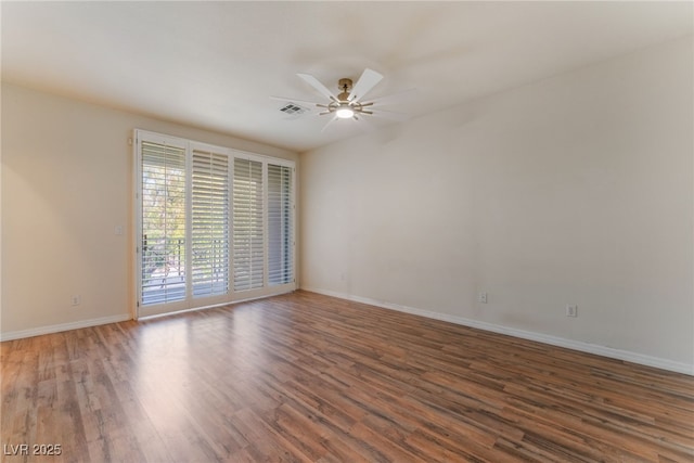 unfurnished room with dark hardwood / wood-style flooring and ceiling fan