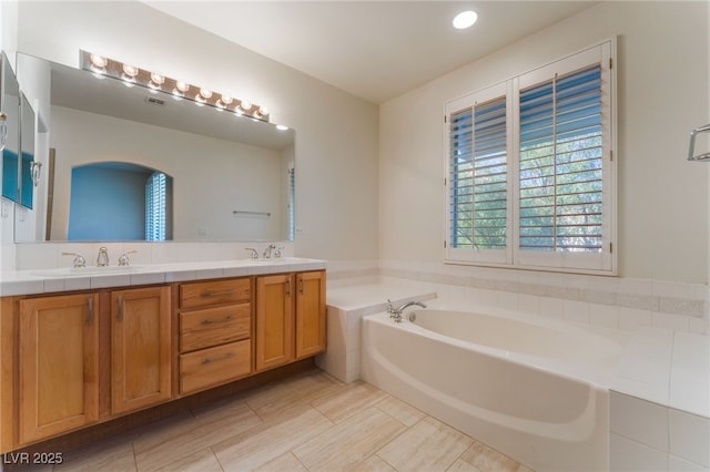 bathroom with vanity and a bathtub