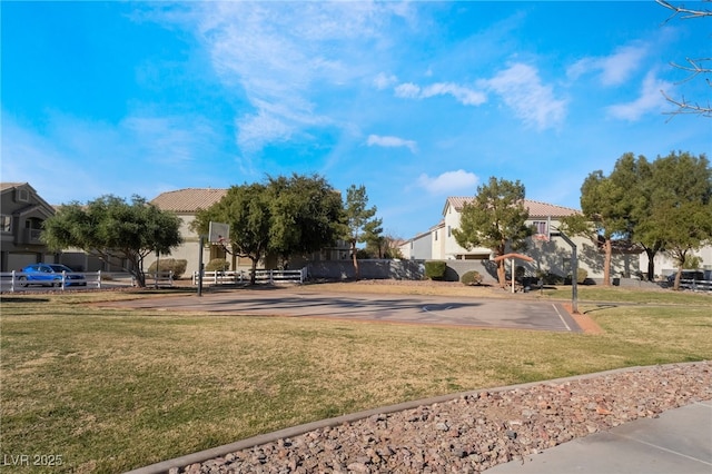 surrounding community with basketball court and a lawn