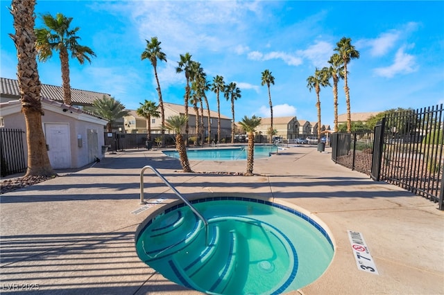 view of swimming pool featuring a hot tub