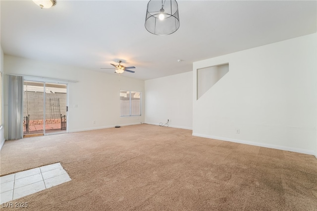 carpeted spare room with ceiling fan