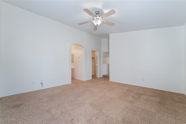 spare room with light colored carpet and ceiling fan