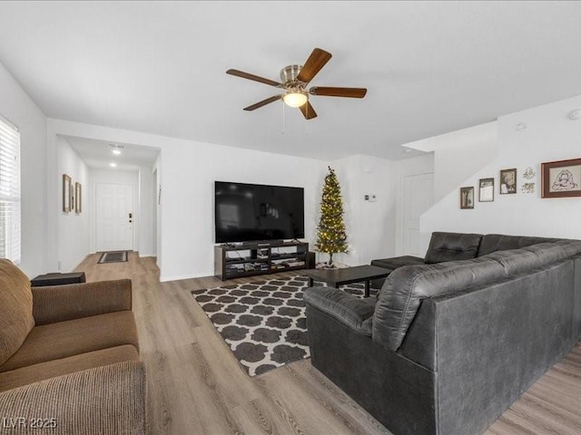 living area featuring light wood finished floors and a ceiling fan