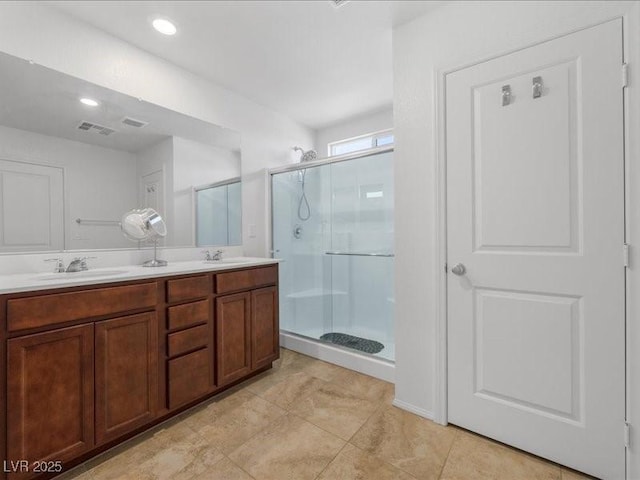 bathroom featuring vanity and an enclosed shower