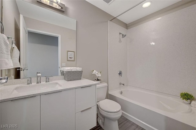 bathroom featuring  shower combination, toilet, wood finished floors, and vanity