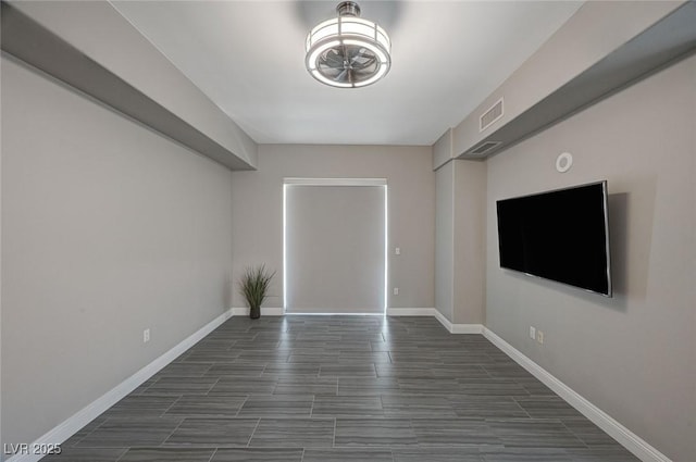 unfurnished room featuring baseboards and visible vents