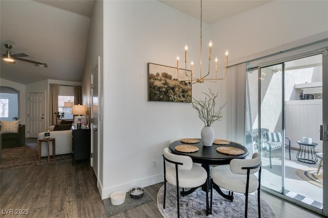 dining room featuring high vaulted ceiling, dark wood-type flooring, and an inviting chandelier