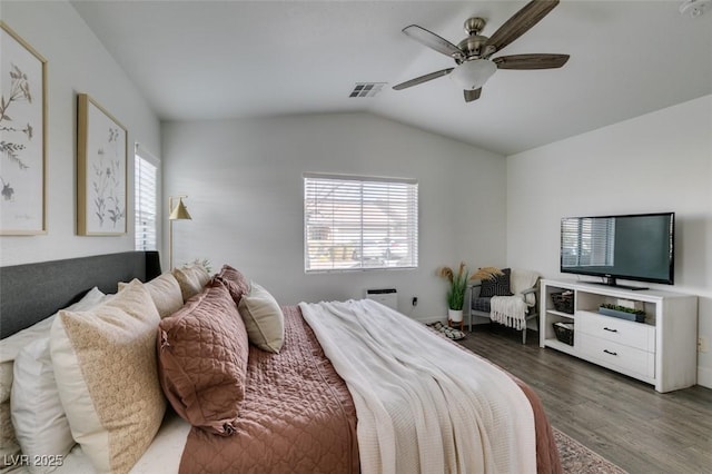 bedroom with dark hardwood / wood-style flooring, vaulted ceiling, and ceiling fan