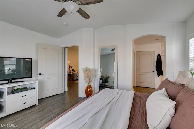 bedroom with ceiling fan, dark hardwood / wood-style flooring, and vaulted ceiling