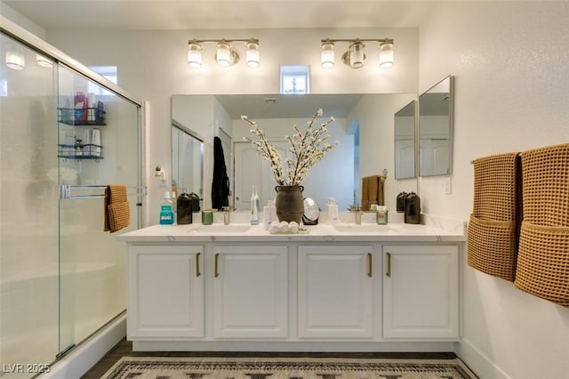 bathroom with vanity and an enclosed shower