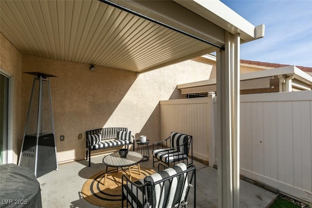 balcony with an outdoor living space and a patio area