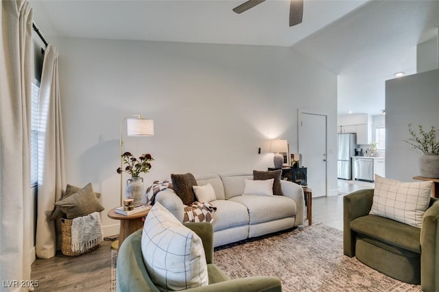 living room featuring lofted ceiling, hardwood / wood-style flooring, and ceiling fan