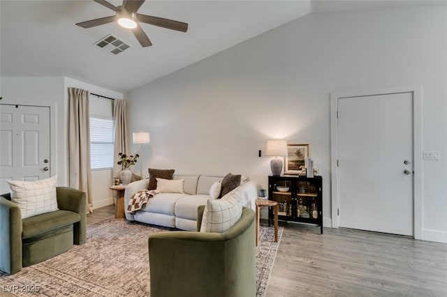 living room with ceiling fan, high vaulted ceiling, and light hardwood / wood-style floors