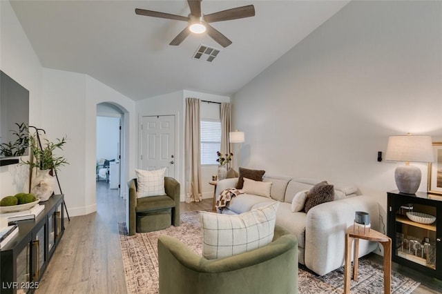 living room with hardwood / wood-style flooring, vaulted ceiling, and ceiling fan