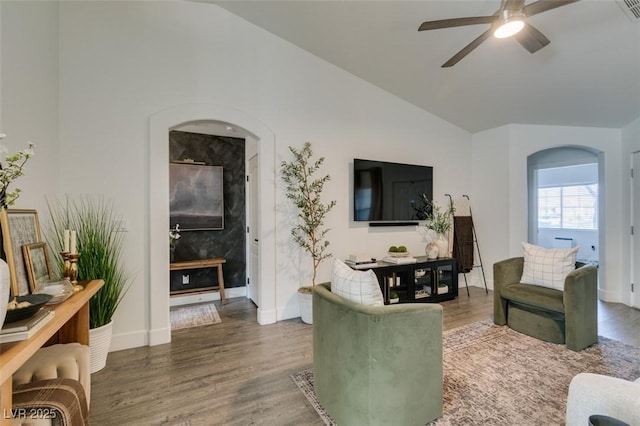 living room featuring ceiling fan, lofted ceiling, and dark hardwood / wood-style floors