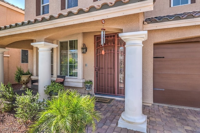 6461 Mount Eden Ave, Las Vegas, NV 89139 - doorway to property featuring covered porch, a tiled roof, and stucco siding
