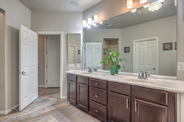 6461 Mount Eden Ave, Las Vegas, NV 89139 - full bath featuring double vanity, wood finished floors, a sink, visible vents, and a shower stall