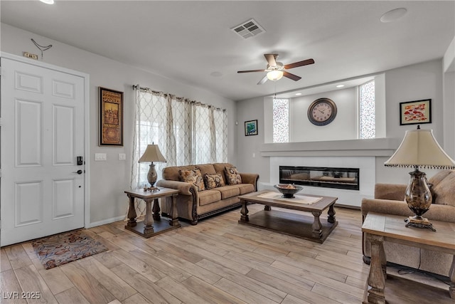 6461 Mount Eden Ave, Las Vegas, NV 89139 - living area with a ceiling fan, light wood-style flooring, recessed lighting, visible vents, and a fireplace