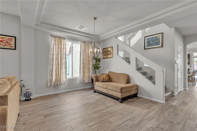 6461 Mount Eden Ave, Las Vegas, NV 89139 - living area with a raised ceiling, stairway, visible vents, and light wood-type flooring