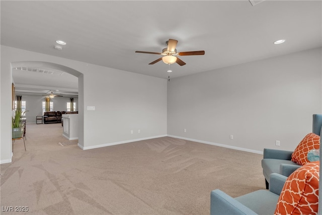 6461 Mount Eden Ave, Las Vegas, NV 89139 - living room featuring light colored carpet, a ceiling fan, arched walkways, and recessed lighting