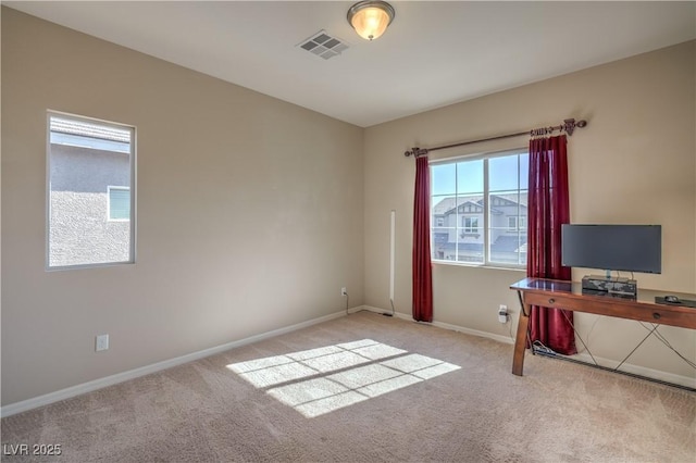 unfurnished office featuring carpet flooring, visible vents, and baseboards