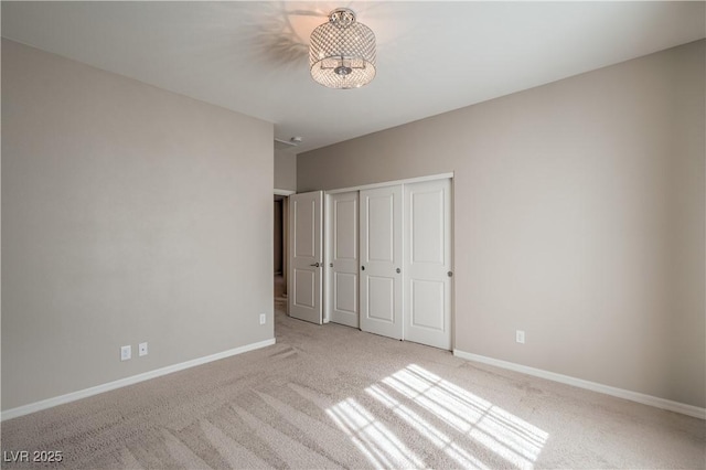 unfurnished bedroom featuring a closet, carpet, and baseboards