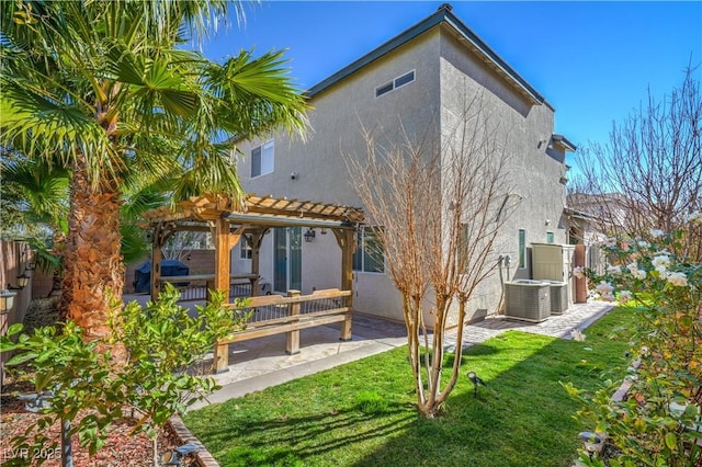 back of property featuring a patio, central air condition unit, a yard, a pergola, and stucco siding