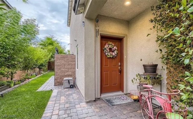 property entrance with stucco siding