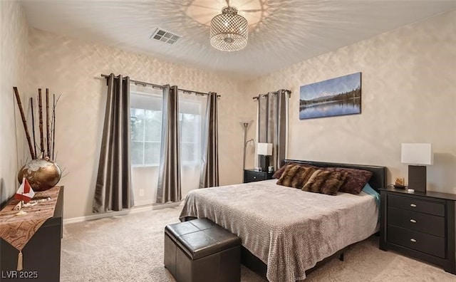 bedroom featuring light carpet and visible vents