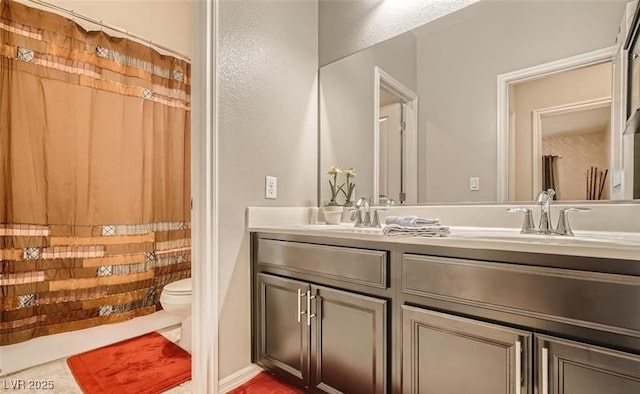 bathroom with toilet, double vanity, a sink, and a shower with shower curtain