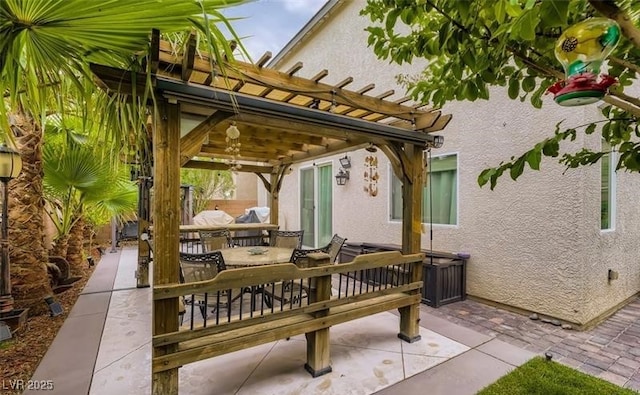 view of patio / terrace featuring a pergola and outdoor dining space