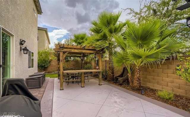 view of patio with outdoor dining area, a fenced backyard, and a pergola