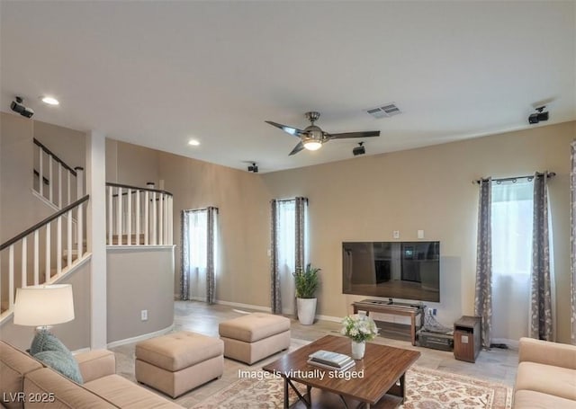 living room featuring ceiling fan, stairs, visible vents, and recessed lighting