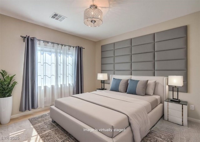 bedroom featuring visible vents and baseboards