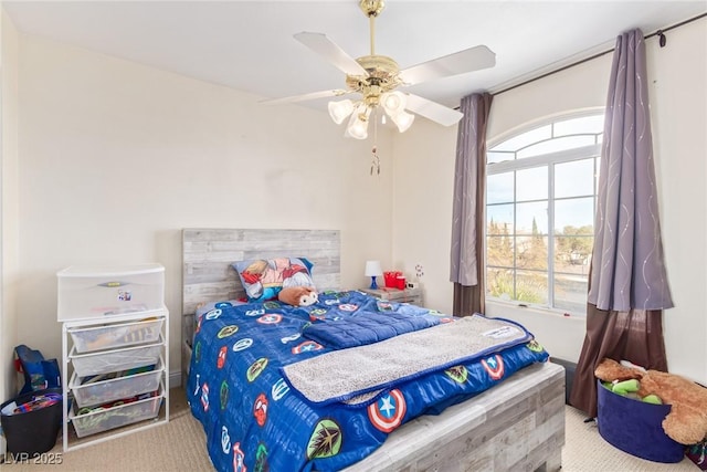 bedroom with multiple windows, light carpet, and ceiling fan